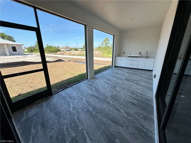 Unfurnished sunroom with sink
