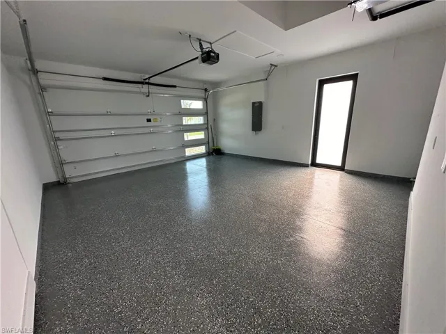 Garage featuring a garage door opener