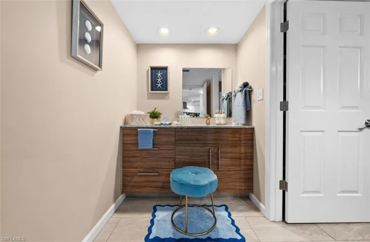 Bathroom featuring vanity, recessed lighting, and light tile patterned floors