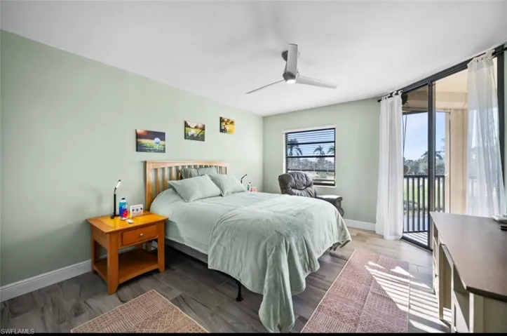 Bedroom with access to exterior, wood finished floors, and ceiling fan