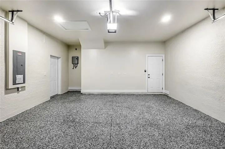 Garage featuring a textured wall and electric panel