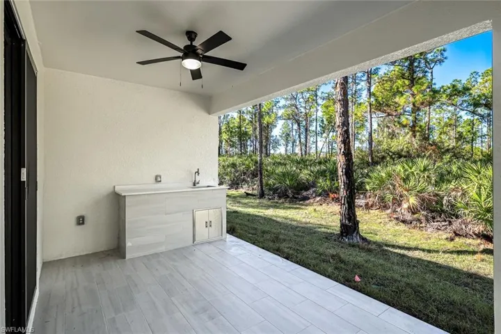 View of patio with a ceiling fan and a sink