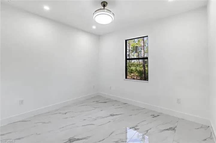 Spare room with light marble finish flooring and recessed lighting