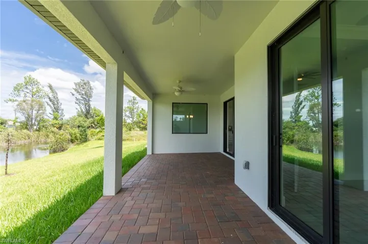 View of patio / terrace with a water view and ceiling fan
