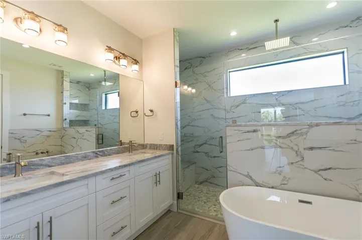 Bathroom with dual vanity, shower with separate bathtub