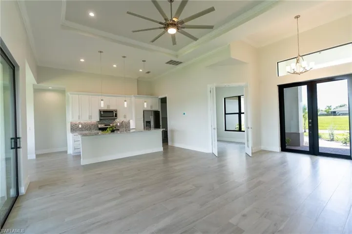 living room with  ceiling fan , crown molding, and a raised ceiling