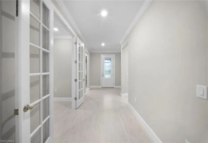 Corridor featuring crown molding, recessed lighting, and light wood-style floors