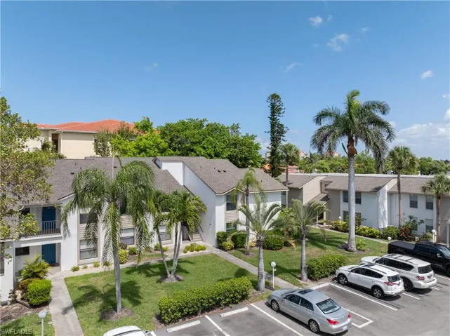 View of property featuring uncovered parking and a residential view