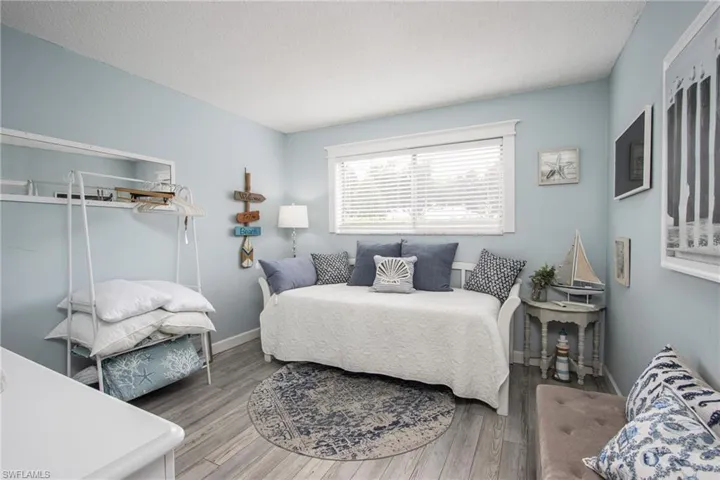 Bedroom with a textured ceiling and hardwood / wood-style flooring