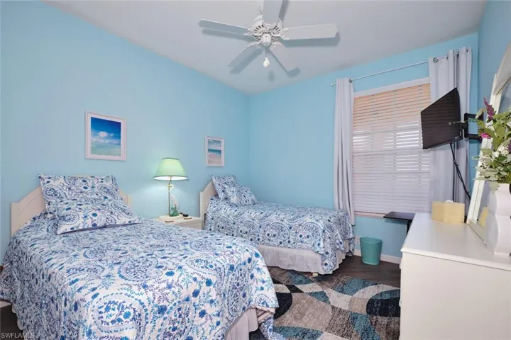 Bedroom with wood finished floors and a ceiling fan