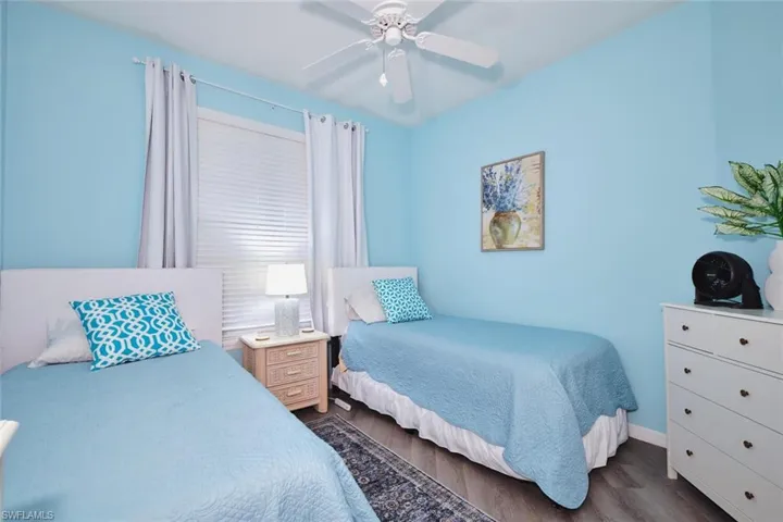 Bedroom with dark wood finished floors and ceiling fan