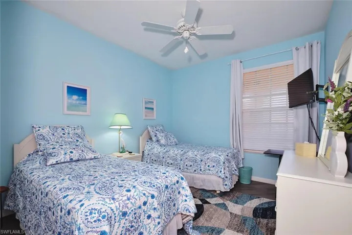 Bedroom with wood finished floors and a ceiling fan