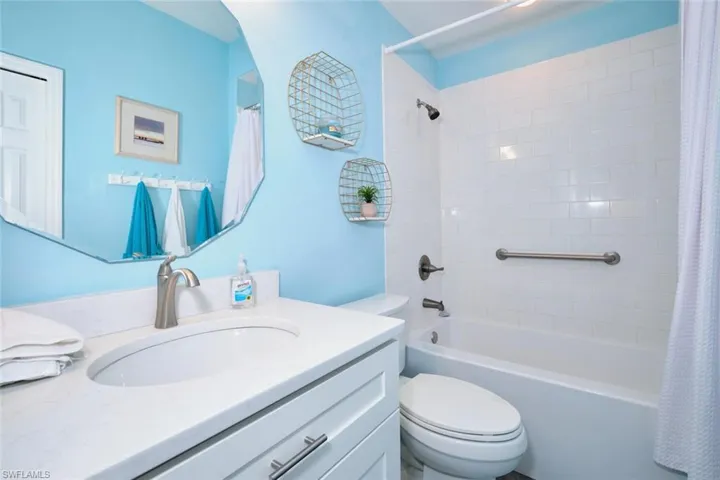 Bathroom featuring shower / bath combo and vanity