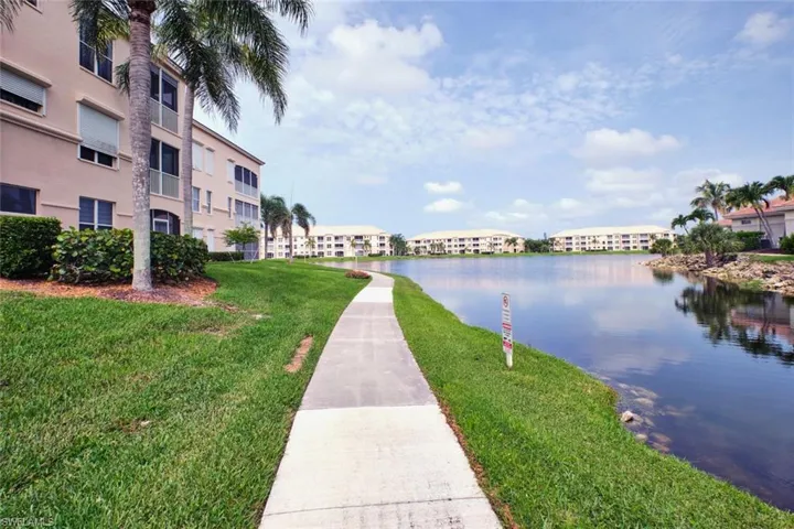 View of home's community featuring a yard, a water view, and a residential view