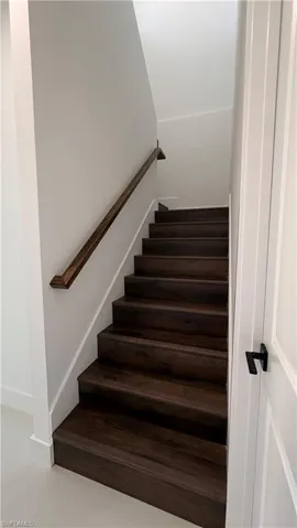 Stairs featuring tile patterned floors