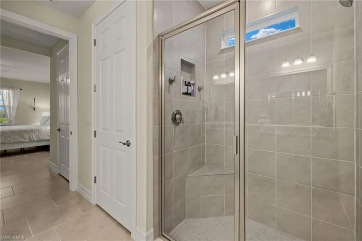 Bathroom featuring walk in shower and tile patterned floors