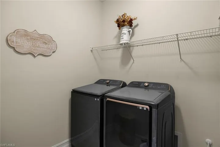 Laundry area featuring washing machine and clothes dryer