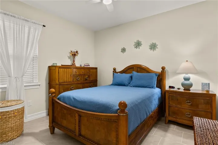 Tiled bedroom with ceiling fan