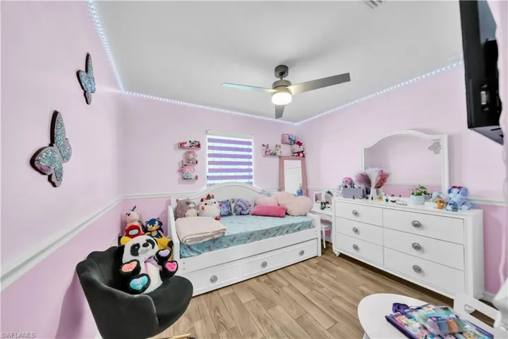 Bedroom with light wood-style floors and ceiling fan