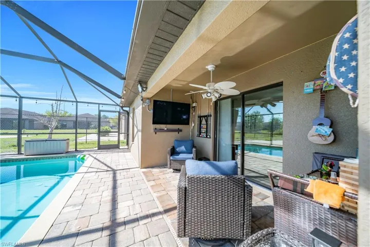 View of patio featuring an outdoor pool, a sunroom, a lanai, and a ceiling fan
