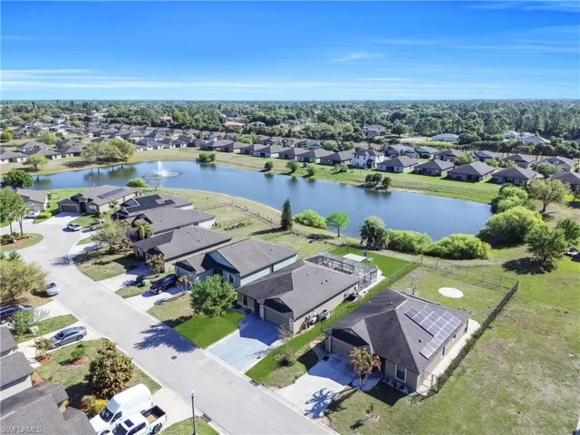 Aerial view of residential area featuring a nearby body of water