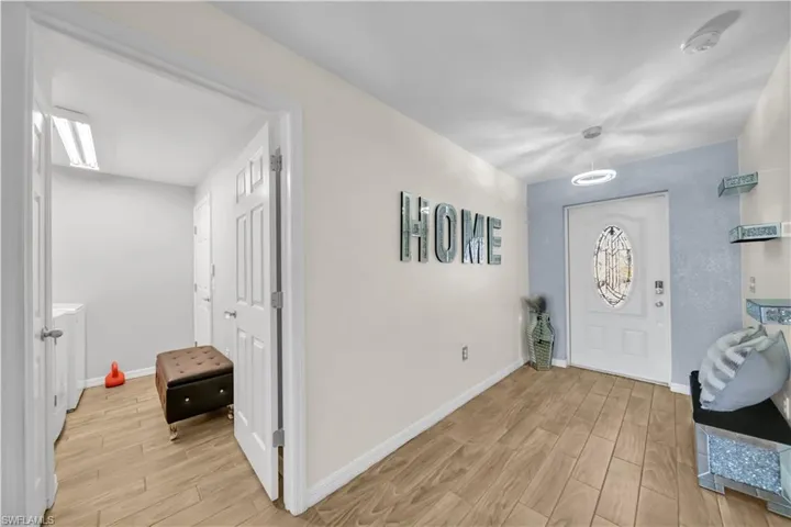 Entryway featuring light wood-type flooring and baseboards