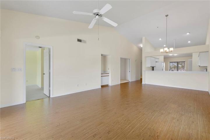 Living/Dining area with light floors & tall ceilings