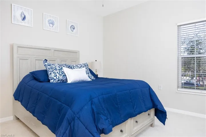 Bedroom with baseboards and carpet