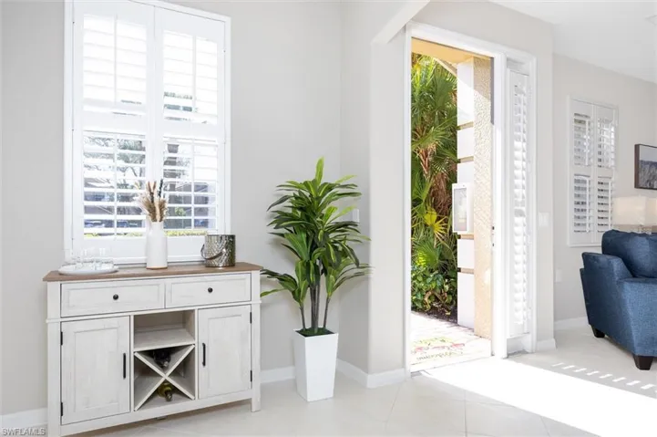 Entryway featuring baseboards and light tile patterned floors