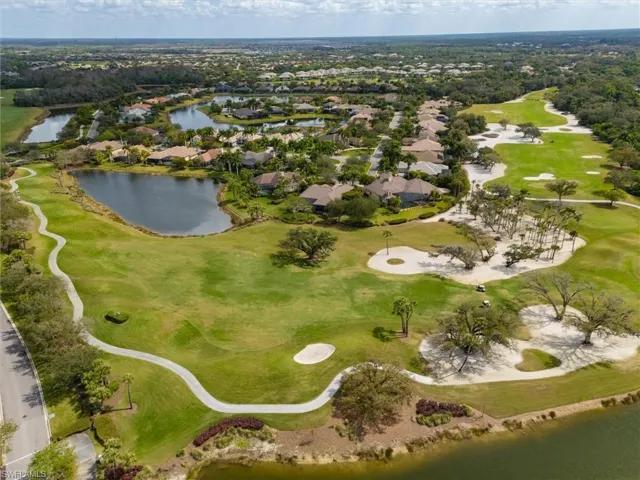 Aerial view of residential area with a large body of water and a golf club
