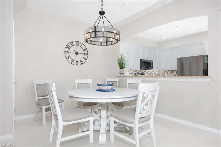 Dining room featuring arched walkways and hanging lights