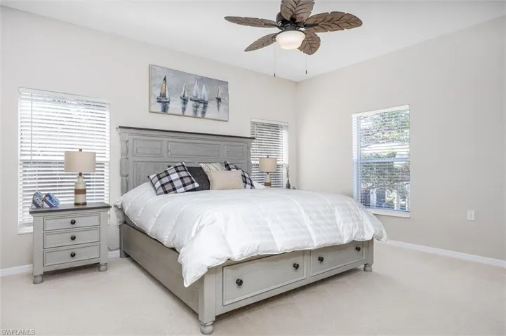 Bedroom featuring light colored carpet and ceiling fan