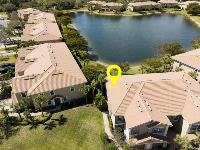 Aerial perspective of suburban area featuring a large body of water