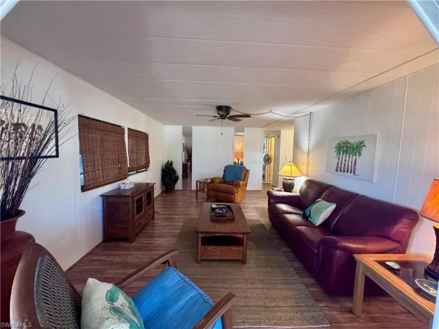 Living room with a ceiling fan and wood finished floors