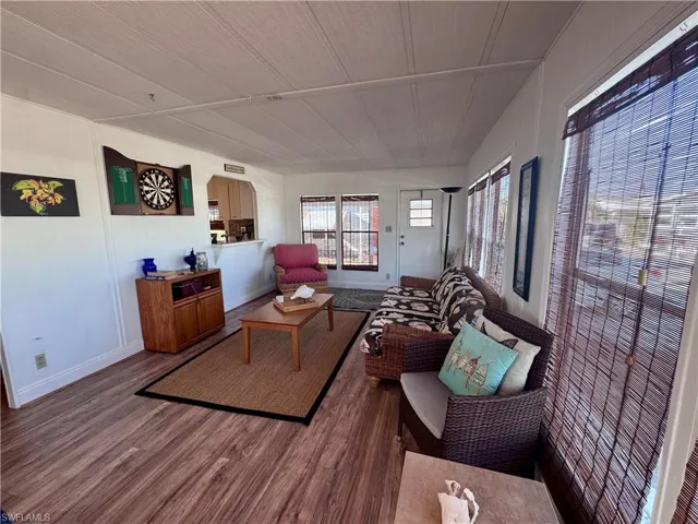 Living area with wood finished floors and baseboards