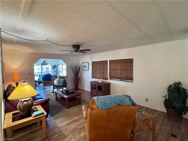 Living room with wood finished floors and a ceiling fan