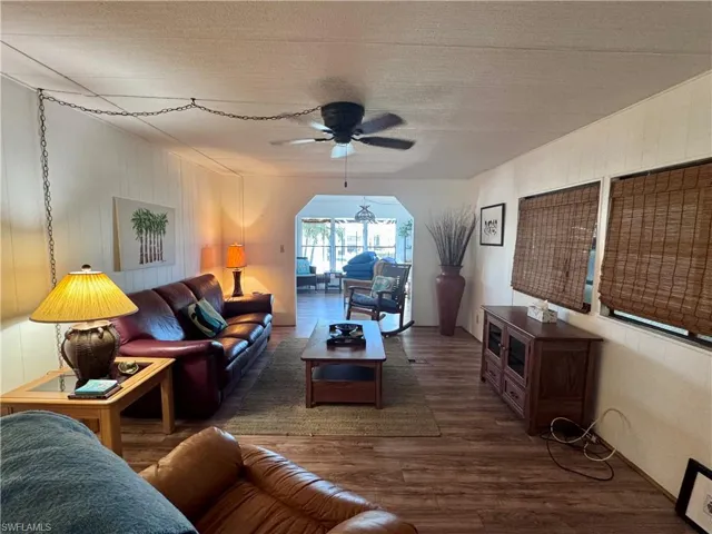 Living room with a ceiling fan and wood finished floors