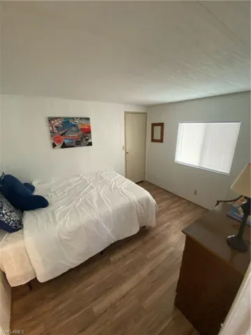 Bedroom with dark wood-style floors