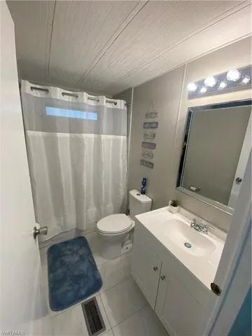 Bathroom featuring vanity, light tile patterned floors, and wood ceiling