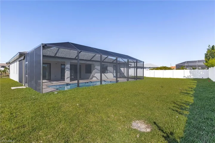 Back of property featuring a lanai, a sunroom, a patio area, and a fenced backyard