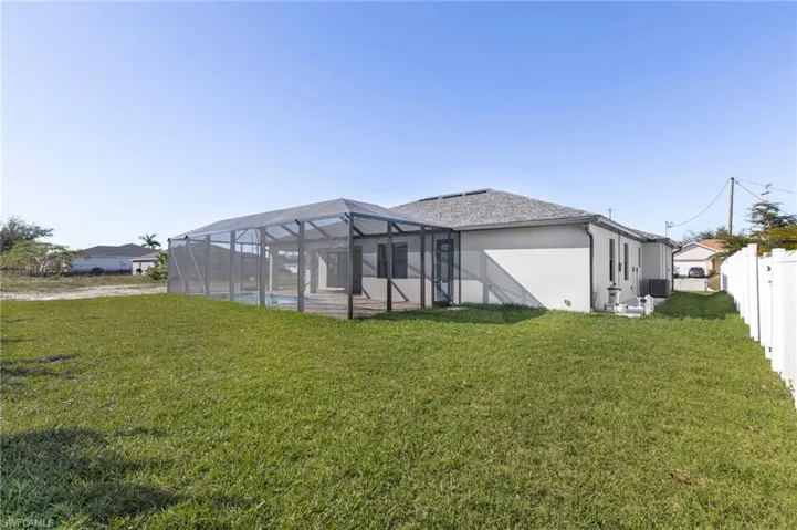 Back of property with a sunroom, glass enclosure, and stucco siding