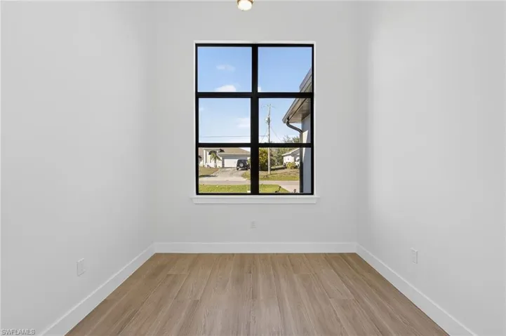 Office area with light wood-style flooring and baseboards