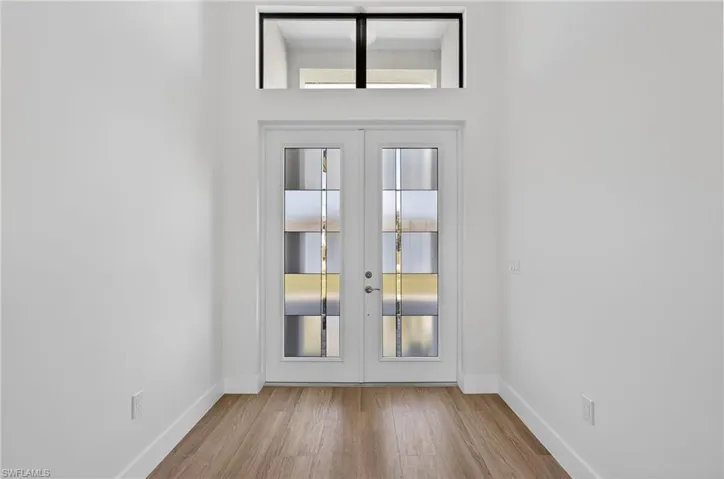 Doorway featuring french doors and wood finished floors