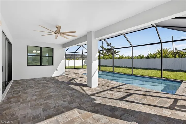 View of swimming pool with a patio area, a sunroom, and a lanai