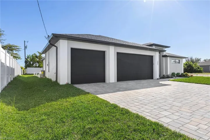 Garage featuring decorative driveway