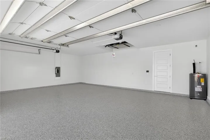 Garage with water heater and electric panel