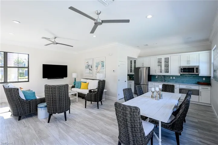 Dining area featuring light hardwood / wood-style flooring, crown molding, and sink