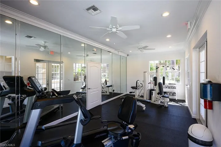 Gym featuring crown molding and ceiling fan