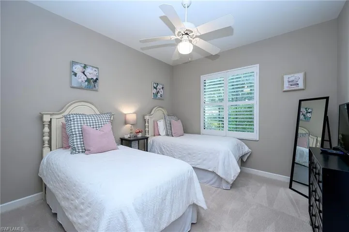 Bedroom featuring ceiling fan and light colored carpet