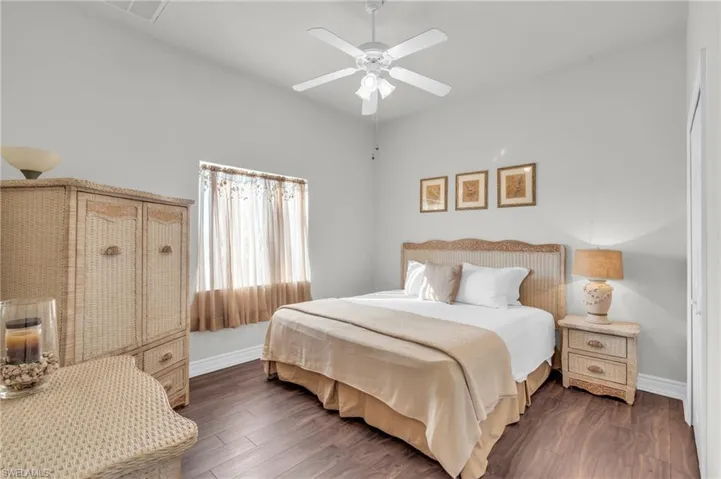 Bedroom featuring ceiling fan and dark hardwood / wood-style flooring